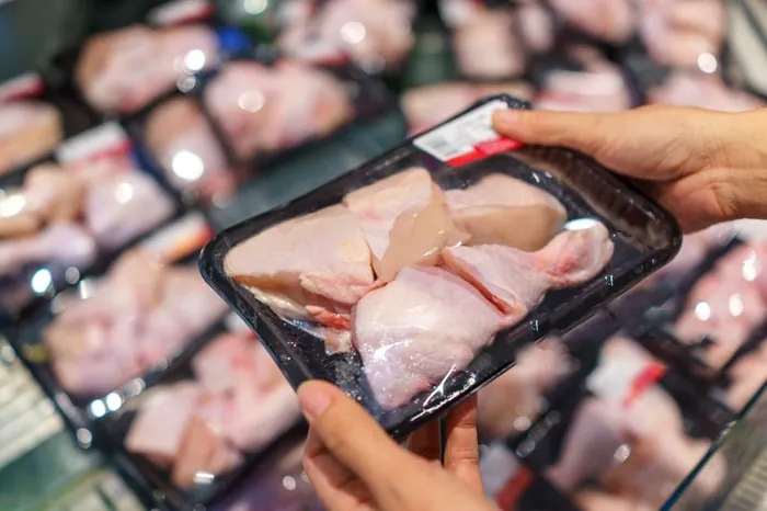 Packaged chicken portions being checked