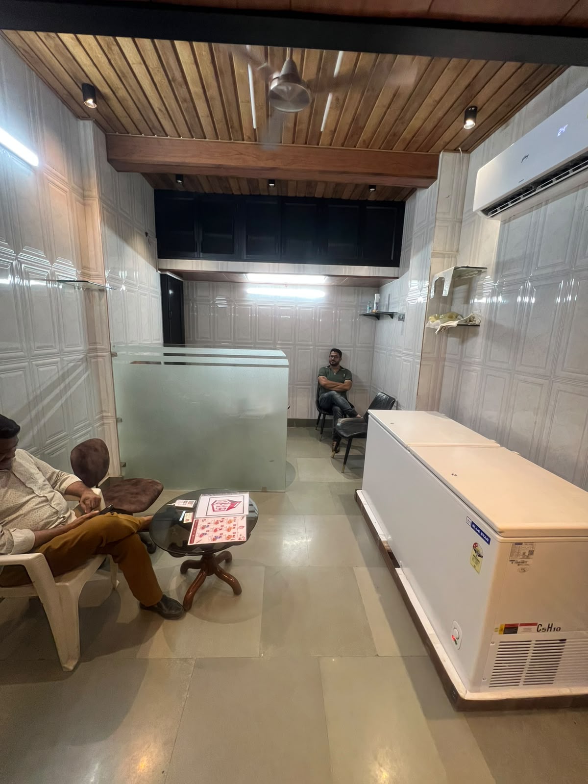 Deli Select shop interior with chest freezers and seating